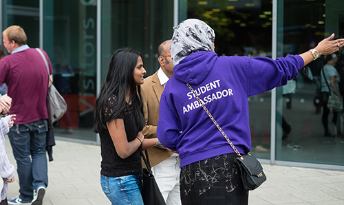 A visitor being pointed in the right direction on an open day