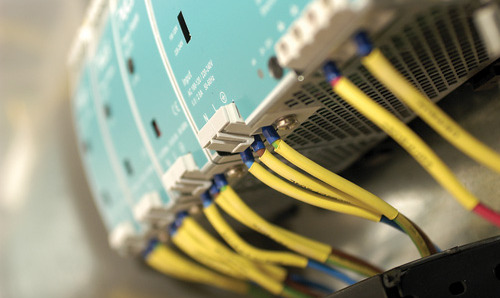 Close up of electronic equipment with yellow wires emerging