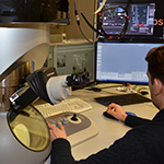 A male researcher using computer equipment in the EM centre