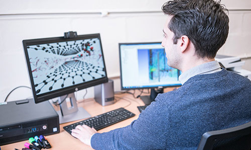 A researcher demonstrating multi-scale modelling on a computer screen