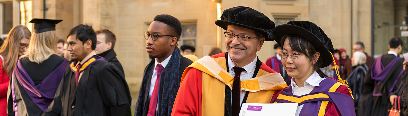 A female postgraduate researcher and her teacher on graduation day